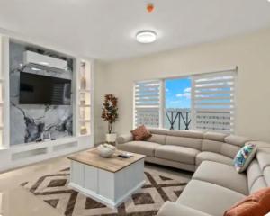 a living room with a couch and a coffee table at Deluxe suite in Portmore