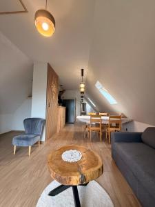 a living room with a couch and a table at Willa Krzesanica in Kościelisko