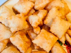 a plate of food with a pile of fried food at Maximus in Bokonbayevo