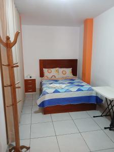 a small bedroom with a bed and a table at La Posada del Inca Chavin in Chavín de Huantar +7 photos