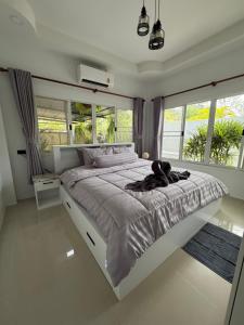 a bedroom with a large bed with a large window at Silver Palm Tree Villa - 2 Bedrooms Villa in Ao Nang Beach +29 photos