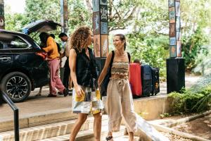 two women walking down the stairs with their luggage at Cinnamon Wild Yala in Yala