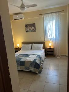 a bedroom with a bed and a window at Iliana House in Neoi Epivates