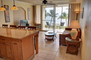 a kitchen and living room with a couch and a table at Hale Kai O'Kihei 302 in Kihei