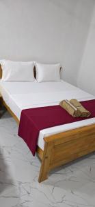 a bedroom with a large bed with a wooden frame at SK Guest House in Jaffna