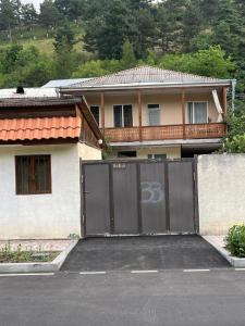 a house with a gate with the number on it at Gokor Guesthouse in Dilijan
