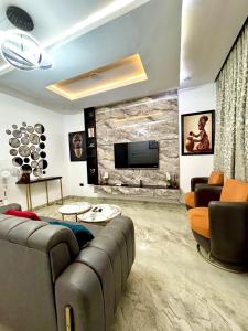 a living room with a couch and a tv at Modern getaway in Ajah in Lekki