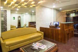 a store with a yellow couch and a table at Itsy Hotels Arastu Inn in Hyderabad