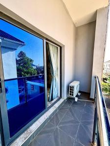 a balcony with a large window with a view at Modern getaway in Ajah in Lekki