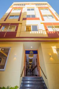 a building with stairs in front of a building at Itsy By Treebo - Arastu Inn in Hyderabad