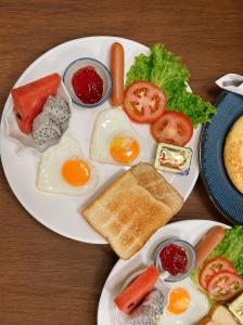 a plate of breakfast food with eggs and toast at Khaosok Bamboo Huts Resort in Khao Sok National Park
