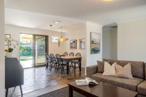 a living room with a couch and a table at Narrawallee Nirvana in Narrawallee