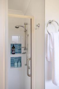 a bathroom with a shower with a glass door at Narrawallee Nirvana in Narrawallee +15 photos