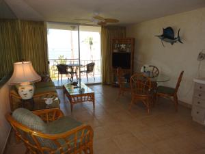 a living room with a couch and a table and chairs at Hale Kai O'Kihei 317 in Kihei