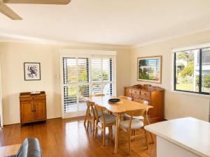 a dining room with a table and chairs at Bawley Beach Bungalow in Bawley Point