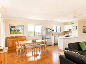 a kitchen and living room with a table and chairs at Bawley Beach Bungalow in Bawley Point +29 photos
