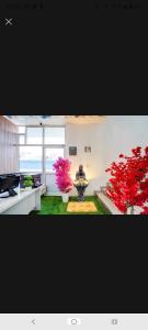 a living room with a large vase and two plants at New Stay Hotel in Gurgaon
