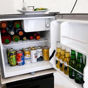 an open refrigerator filled with lots of drinks at Hotel Montserrat in Valledupar