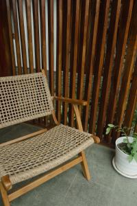 a wooden bench sitting next to a potted plant at Mango Garden Villas in Sekongkang Bawa