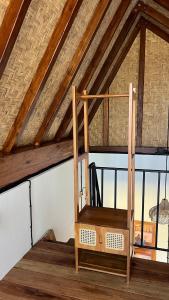 a wooden shelf in a room with a window at Mango Garden Villas in Sekongkang Bawa