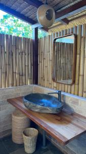 a blue sink on a wooden table with a mirror at Mango Garden Villas in Sekongkang Bawa +1 photo