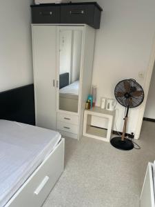 a bedroom with a bed and a mirror and a fan at residence st marguerite in Antibes