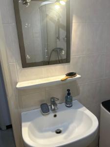 a bathroom with a sink with a mirror and a mirror at residence st marguerite in Antibes +4 photos