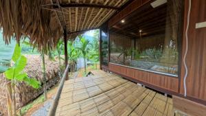 a wooden walkway to a house with a view of the ocean at Pu Luong Roots Homestay in Pu Luong