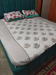 a bed with two pillows on top of it at Osween Guest House in Srinagar