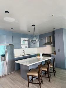 a kitchen with a sink and a table with chairs at Sol y mar in Rosarito Beach