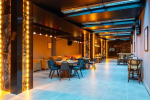 a restaurant with tables and chairs and a bar at Barida Hotels Davraz in Cobanisa