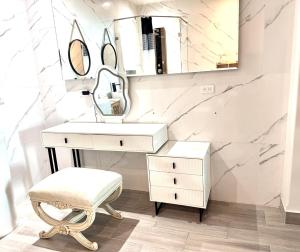 a bathroom with a sink and a mirror and a stool at Sol y mar in Rosarito Beach +22 photos