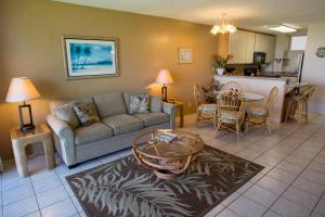 a living room with a couch and a table at Kauhale Makai 335 in Kihei