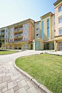 a large apartment building with a lawn in front of it at Zalakaros Wellness Oázis Apt, nappali, 1háló, 4 fő in Zalakaros