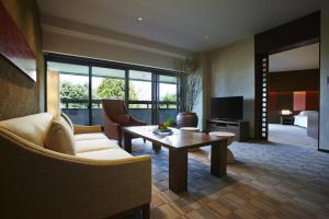 a living room with a couch and a table at Hyatt Regency Kyoto in Kyoto