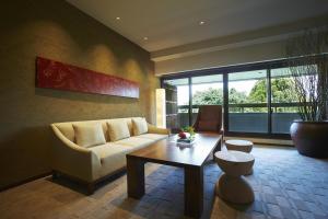 a living room with a couch and a table at Hyatt Regency Kyoto in Kyoto