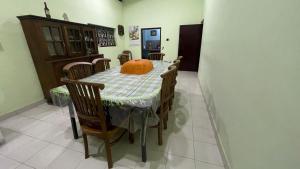 a dining room with a table with a pumpkin on it at Reefside mount villa in Deniyaya