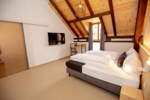 a bedroom with a large bed with a wooden ceiling at Alter Hafen Marktsteft in Marktsteft