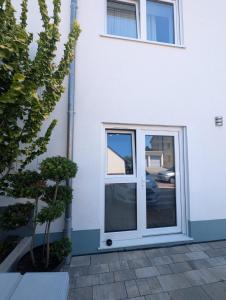 a sliding glass door on a white building at Nathalie in Bad Vilbel