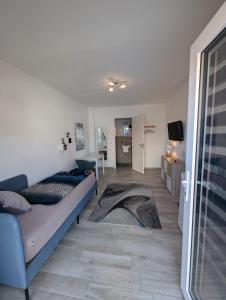a living room with two beds and a television at Nathalie in Bad Vilbel
