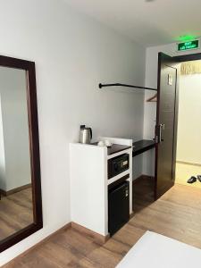 a small kitchen with a stove and a refrigerator at TimeOut Dalat Boutique Hotel in Khu Chi Lăng
