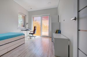 a bedroom with a bed and a desk at Pavilnis house in Vilnius