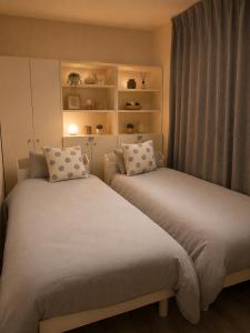 a bedroom with two beds and a window at 不二咲 in Fujiyoshida