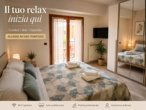 a bedroom with a bed with a couch and a mirror at Appartamento Magnolia 209 in Pomezia