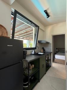 a kitchen with a black refrigerator and a bedroom at athanasia sea view home front house in Polychrono