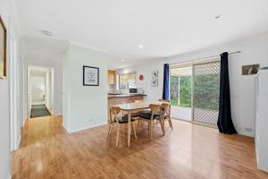 a kitchen and dining room with a table and chairs at Serrell by the Sea in Inverloch