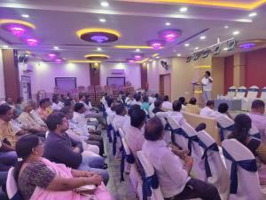 a group of people sitting in chairs in a room at ks grand function hall in Jāmb