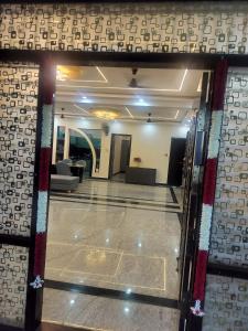 a view of a lobby through a glass door at ks grand function hall in Jāmb