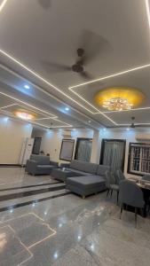 a living room with couches and chairs in a room at ks grand function hall in Jāmb