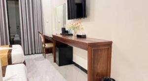 a room with a desk with flowers on it at Meatophum Samnang in Battambang +21 photos